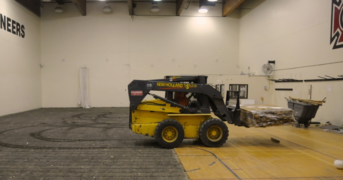 Workers stack the floor of the PEC gym for reuse