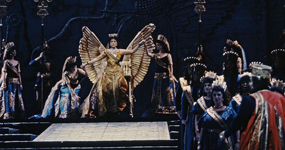 A woman rises from a winged throne.">.<t="