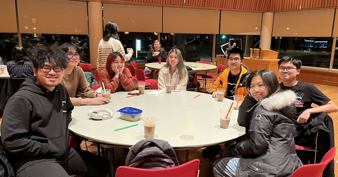 Students relax around a table with bubble tea all around