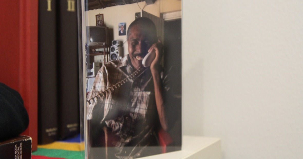 Picture of a printed photo of a Grinnell SOL alum on the telephone