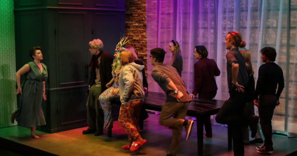 Production: Do You Feel Anger. Actors do a dance during curtain call in a pool of rainbow light.