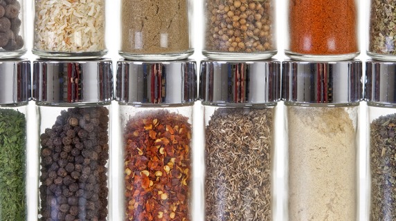 row of spices in small, clear glass jars