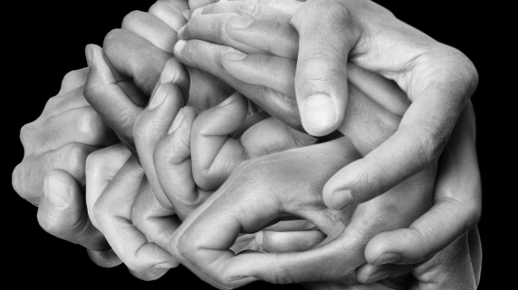 Hands overlapping in the shape of a brain