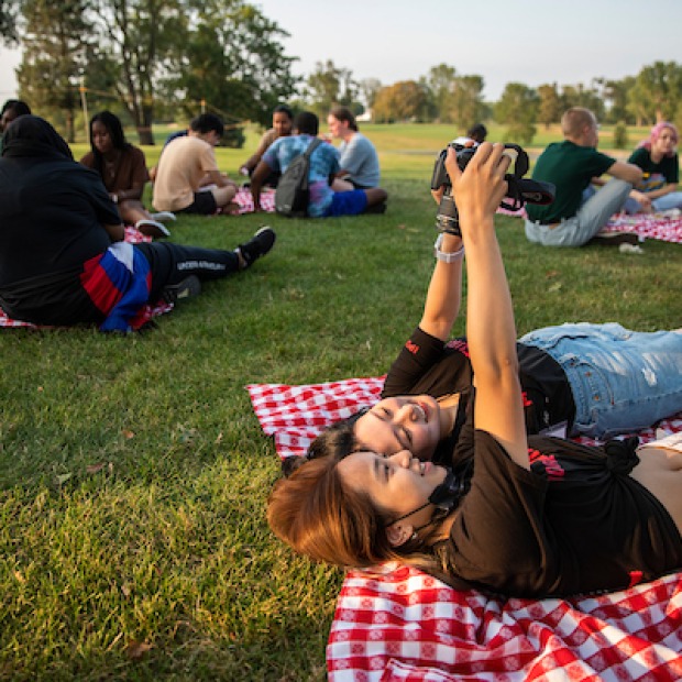 students take selfies at pre-orientation picnic