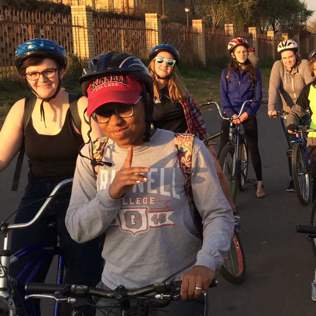 People on a bike tour in South Africa. The one in front is wearing a Grinnell College sweatshirt and cap