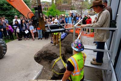 Crowd watches as John Whittaker oversees the forklift drawing the Peace Rock out of it's hole. 