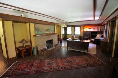 Interior of Ricker House main room including tiled mural above the fireplace