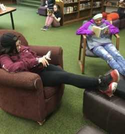 Students reading new books in the library