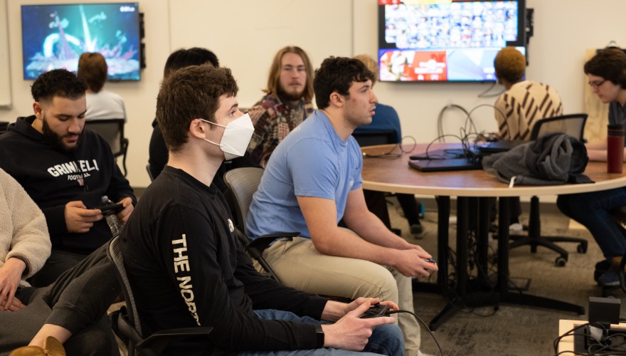 A group of students play Smash on their controllers.