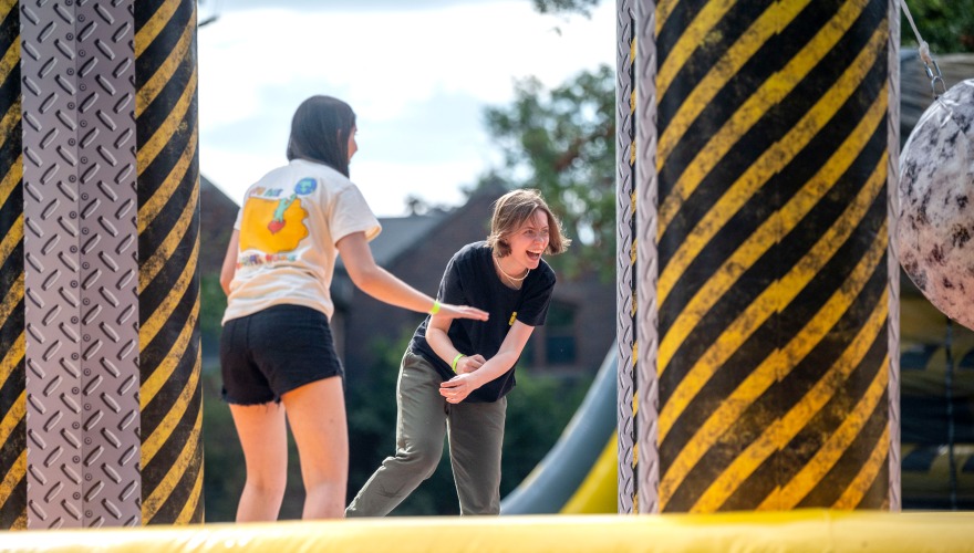 two students playing on inflatable 