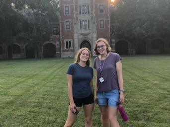 Two girls standing in front of building