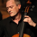 Headshot of Alan Henson playing cello