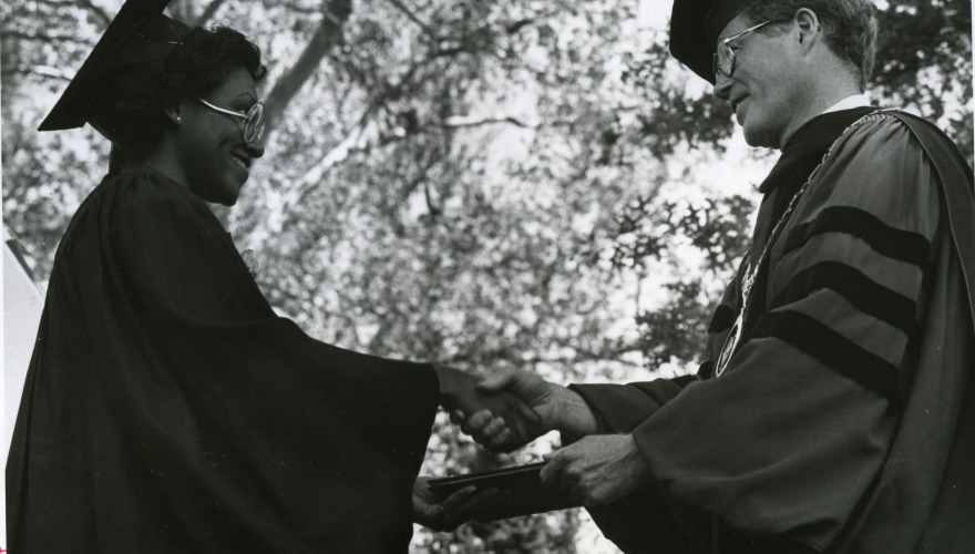 Commencement, 1981. Grinnell College president, George Drake, shakes hands with Katherine Hill (class of 1981). 