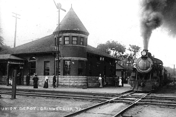 people standing around Union Depot as train steams in