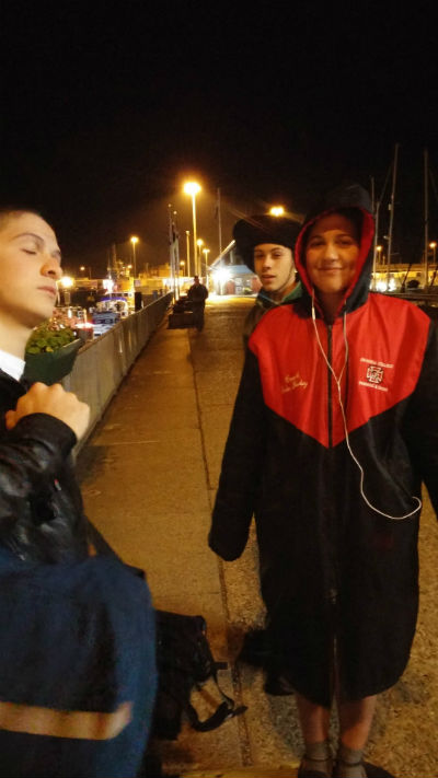 Delia Salomon in red and black jacket with Honor G logo on the upper left.