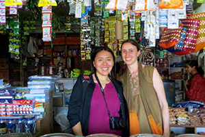 Diana Jue and Jackie Stenson in a street vendor stall in India