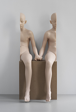 Sculpture that appears to be a person in two halves, swapped left to right and holding hands