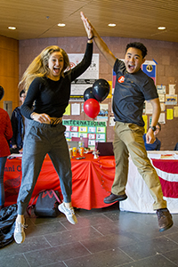 Two people jumping and sharing a high-five