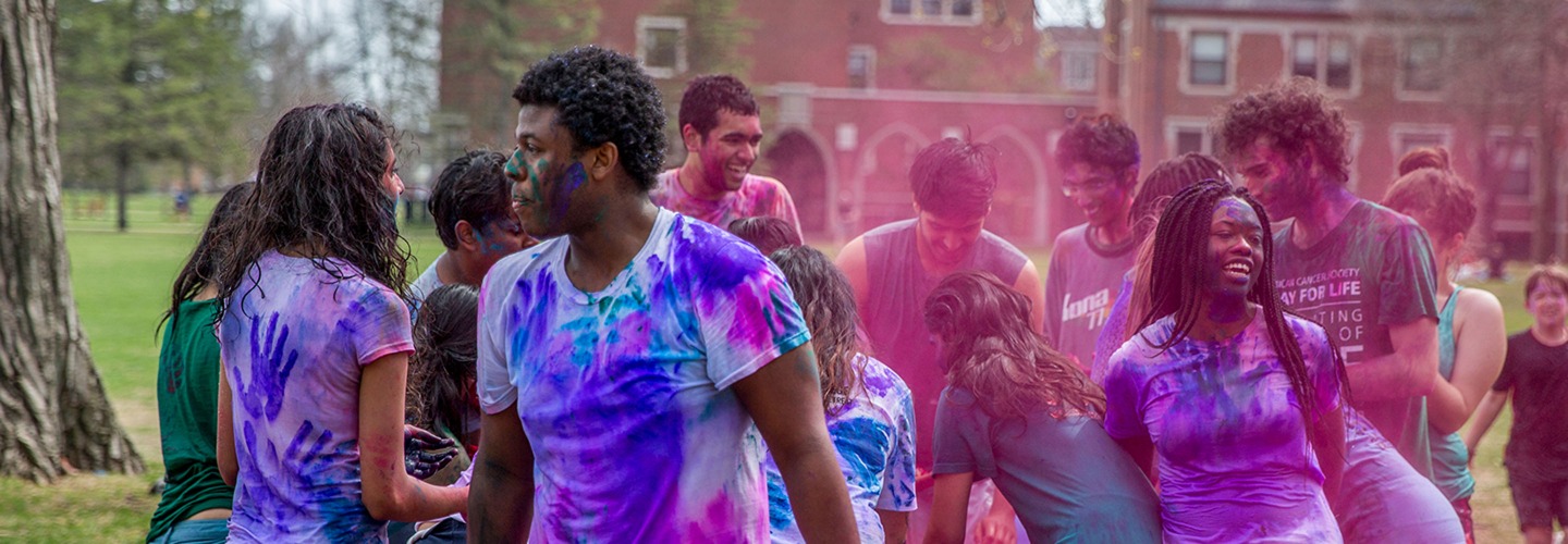 students celebrate Holi with colored powders