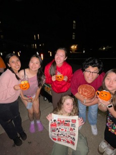 6 students smile with their fall-themed prizes at the QuestBridge s'mores event