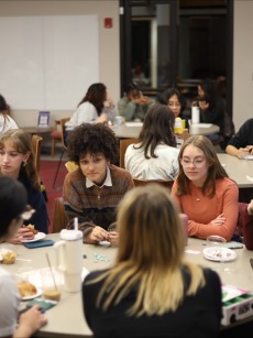 a group of students share snacks and play games in honor of Quest Day