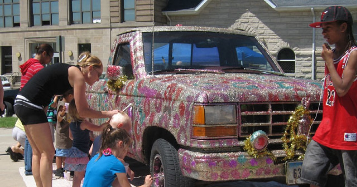young people decorate a truck with glitter