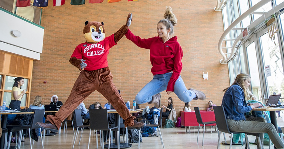Student and squirrel mascot celebrating Give Back Day
