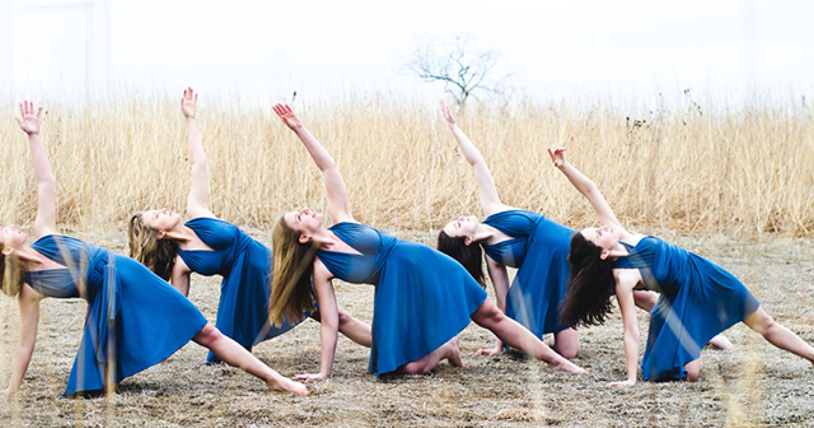 Dancers in blue dresses on the prairie