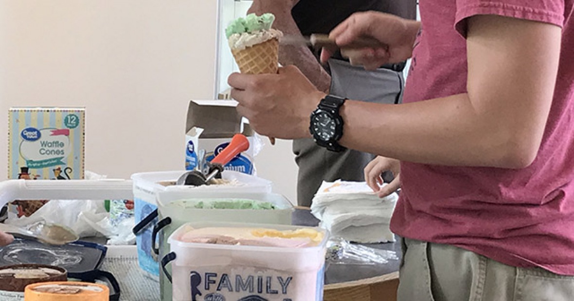 Student scooping ice cream during annual Ice Cream Social