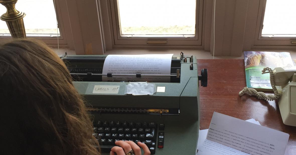 back of student at typewriter