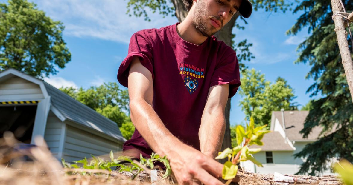 Jacob Friedman plants a seedling in the garden