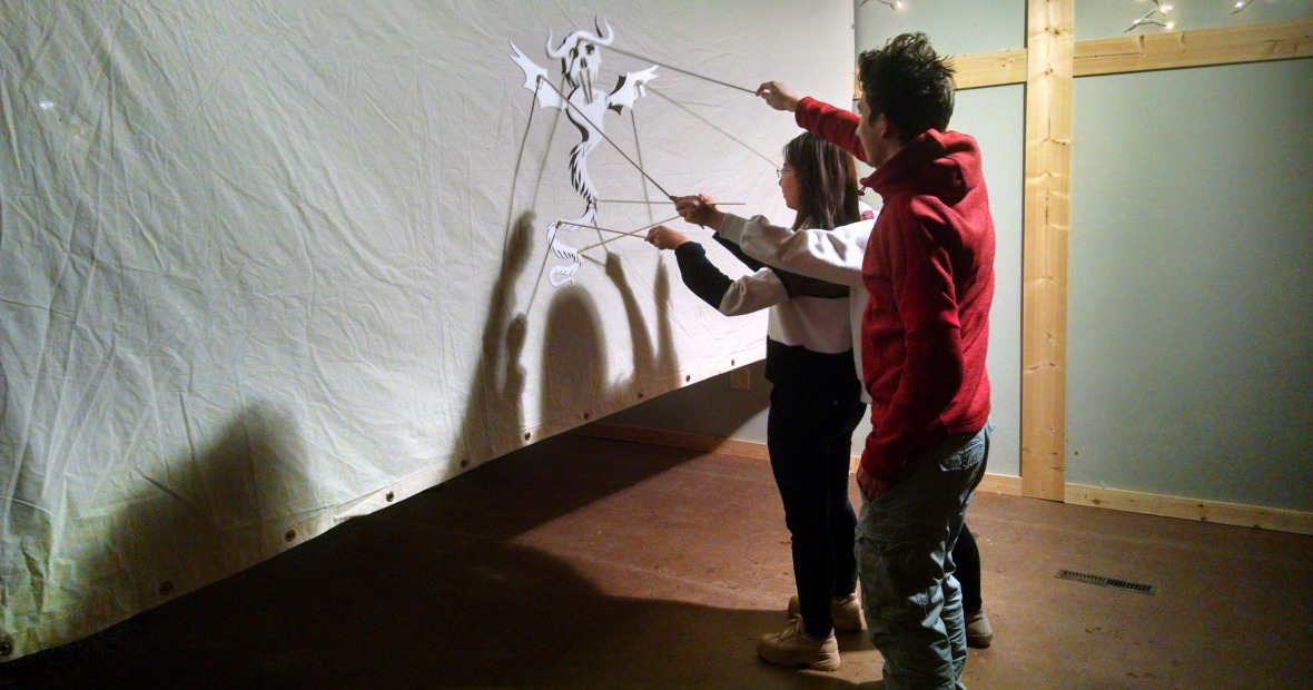 Two students using shadow puppet