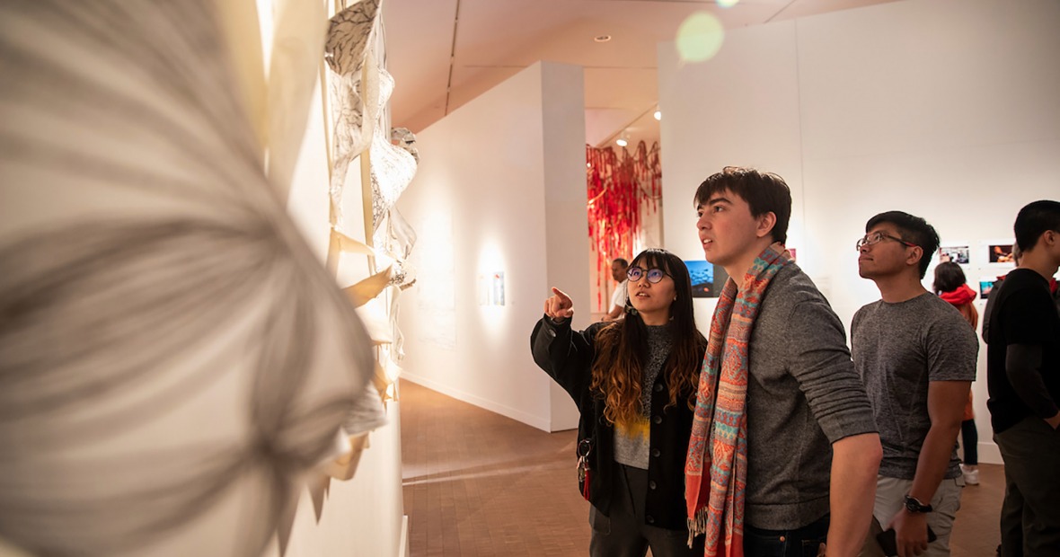Students examine artwork at BAX