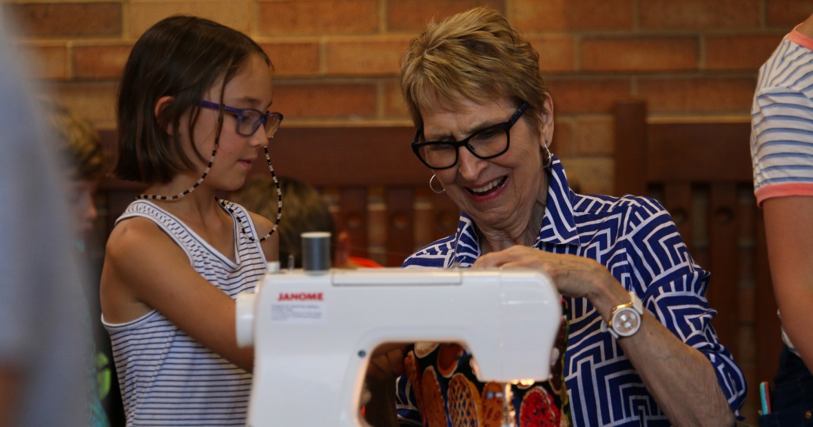 Woman and young girl at sewing machine exploring on quilting techniques