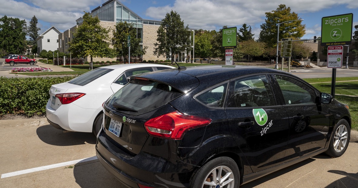 Two zipcars parked in lot across from Chrystal Center