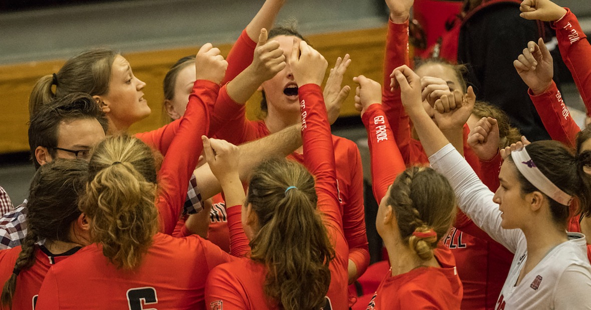 Women's volleyball team huddles together