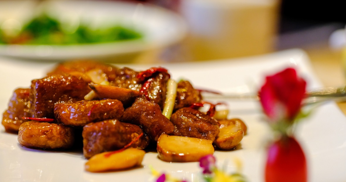 stir-fried beef on a plate at a restaurant
