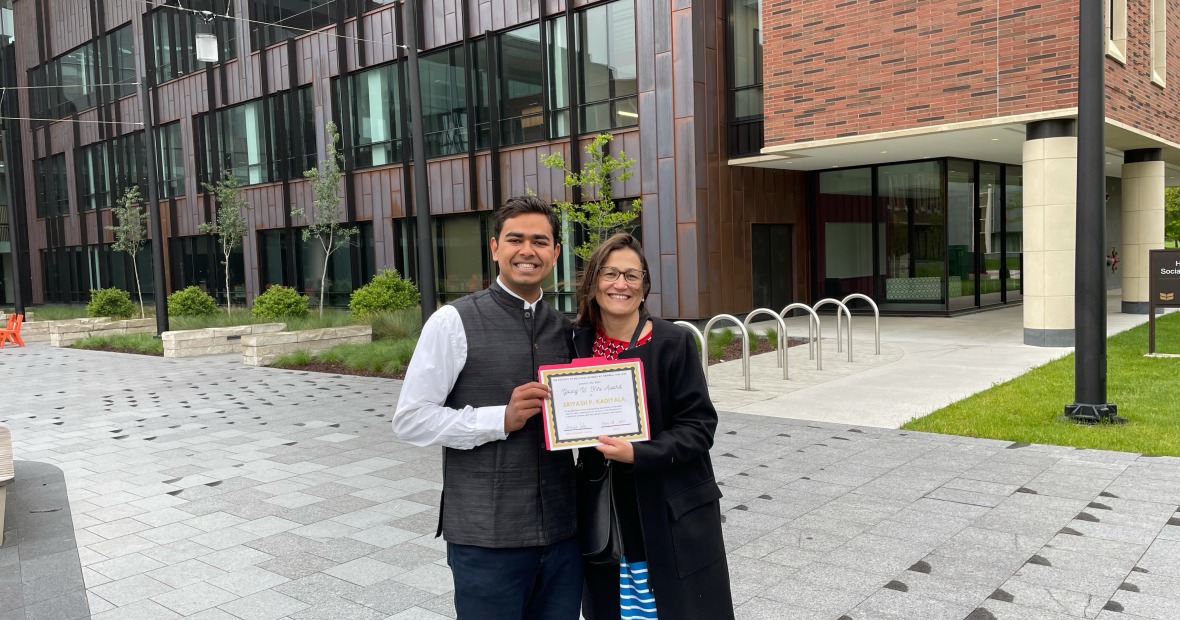 Sriyash Prajval Kadiyala ’21 and professor Gemma Sala hold award outside HSSC