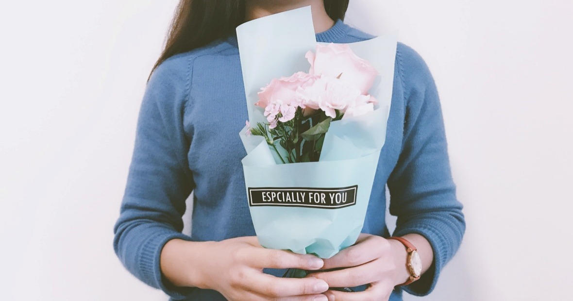 Woman holding bouquet that says Especially For You