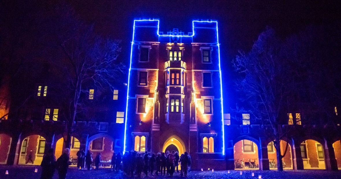 Gates Tower lit up in blue Christmas lights.