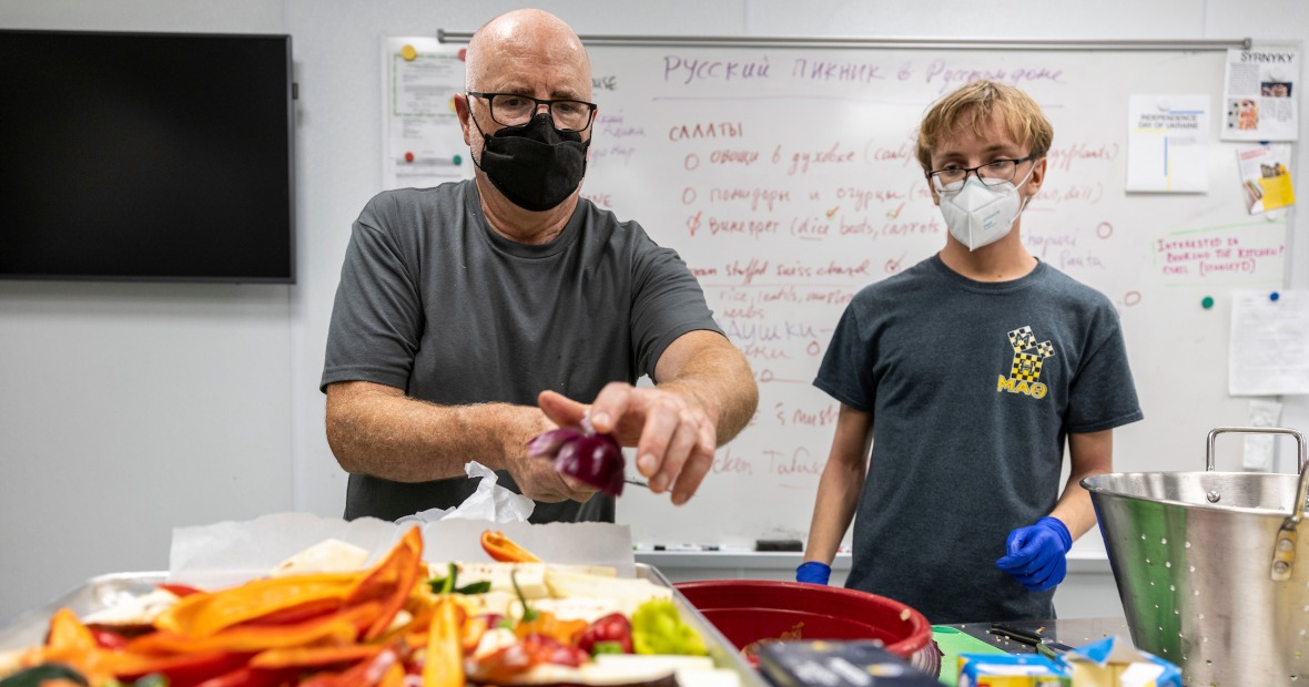 Professor Todd Armstrong prepares a meal with a student in the Global Kitchen