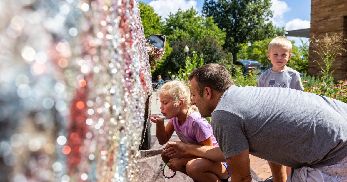 family putting glitter on art truck