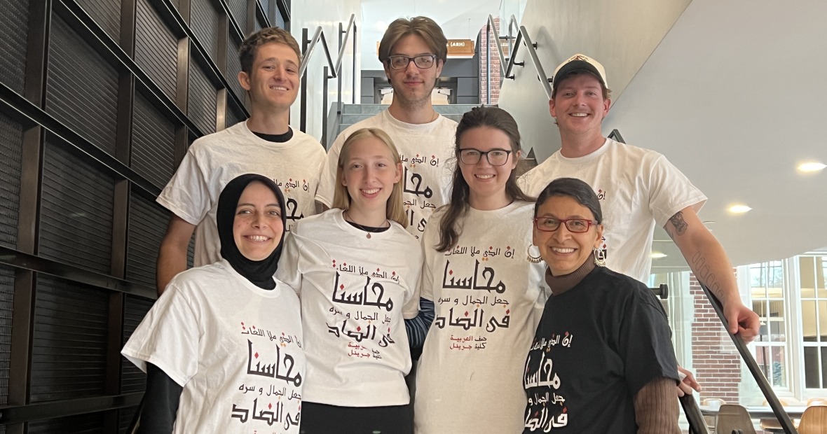 Arabic 221 students standing on stairs showing off their class t-shirts