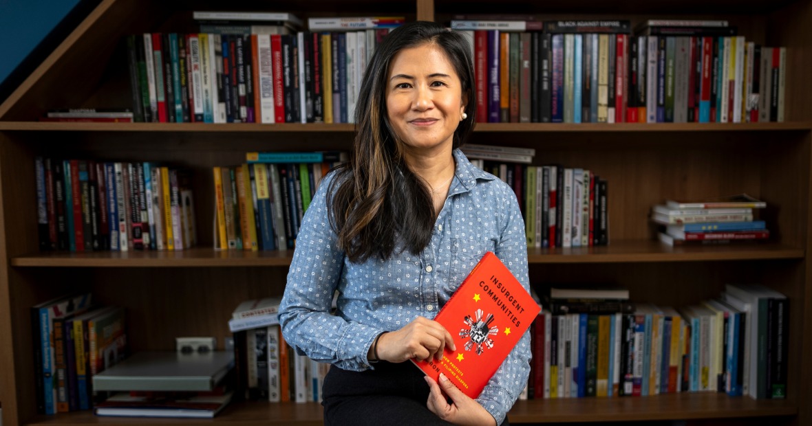 Sharon Quinsaat holds a copy of her new book.