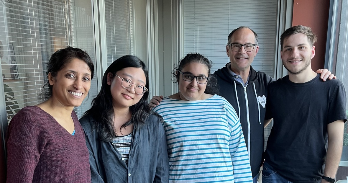 Professor Mark Levandoski, two current Grinnell students, and two alumni pose for a photo
