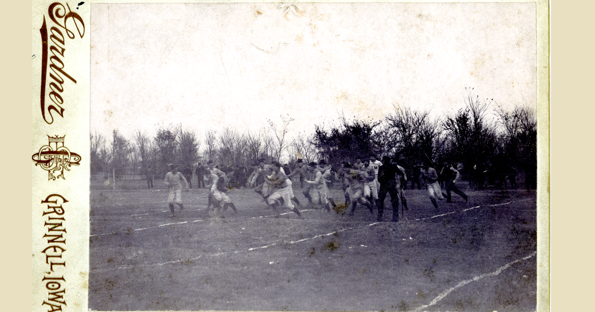 An old black and white photo postcard showing an 1890s Grinnell football team in action