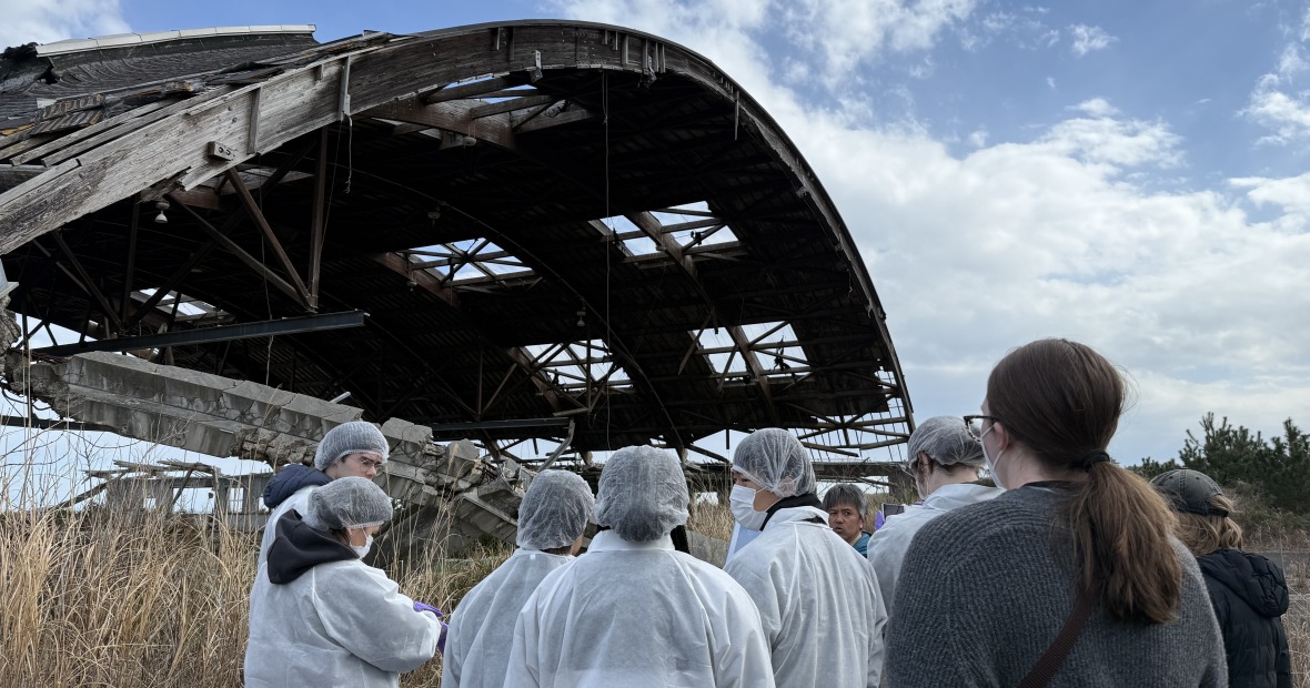 Mr. Norio Kimura and students outside a seafood processing plant.