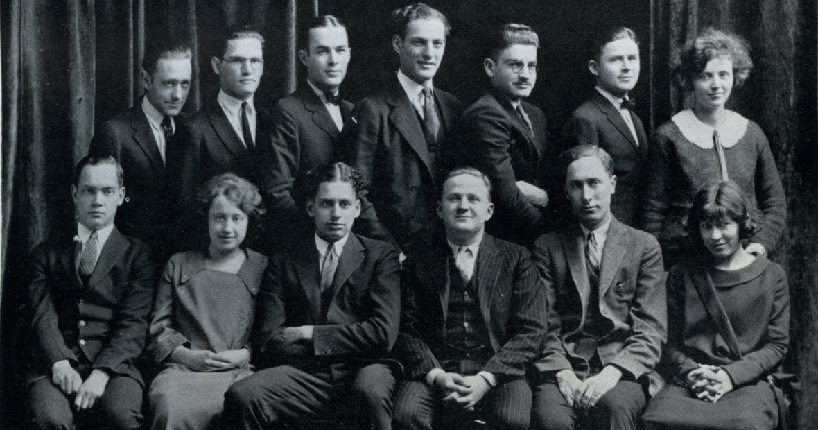 A black and white vintage photo of about a dozen young men and women in two rows