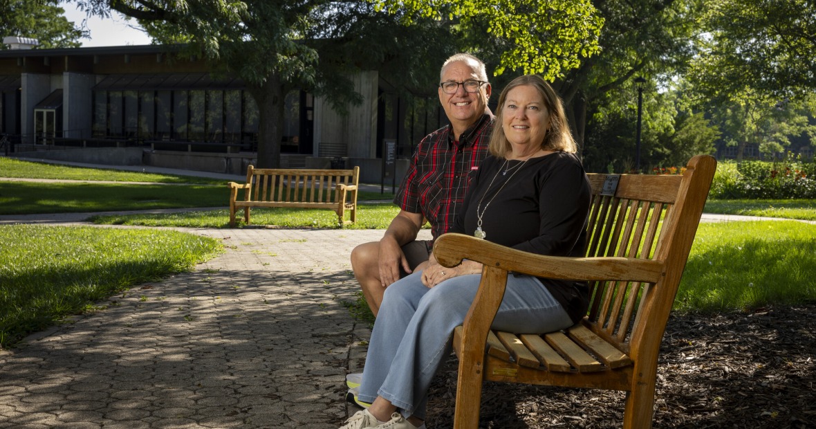 Scott and Laura Shepherd sitting on a bench in central campus 