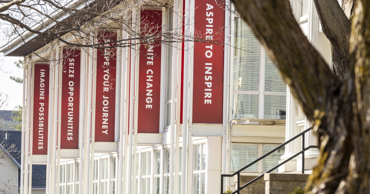 Exterior of the Center for Careers, Life, and Service building with red banners flying